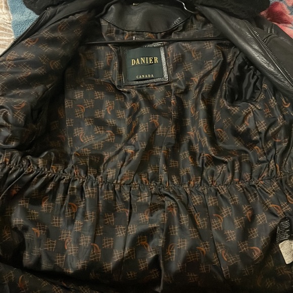 This is a huge leather jacket with fur lining at neck. - Picture 3 of 5